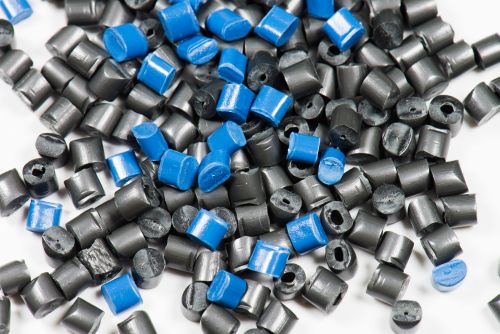 blue and black plastic granulate for injection moulding on white background